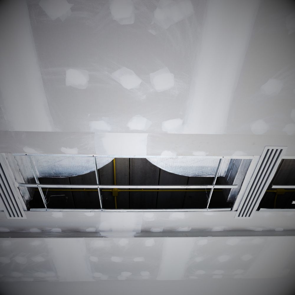 Ornate plaster ceiling in a restaurant, with intricate moldings and a warm, inviting ambiance