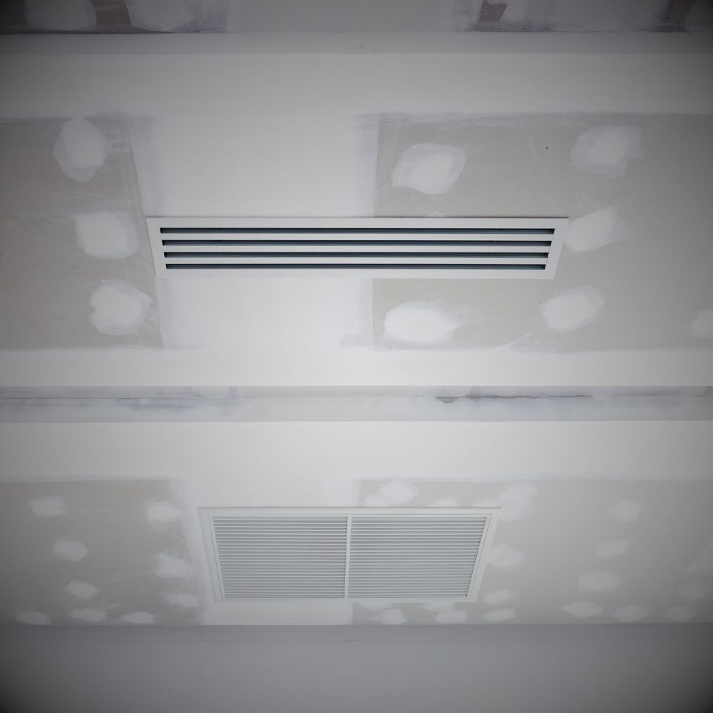 Retail store interior showcasing a decorative plaster ceiling with patterned designs and accent lighting