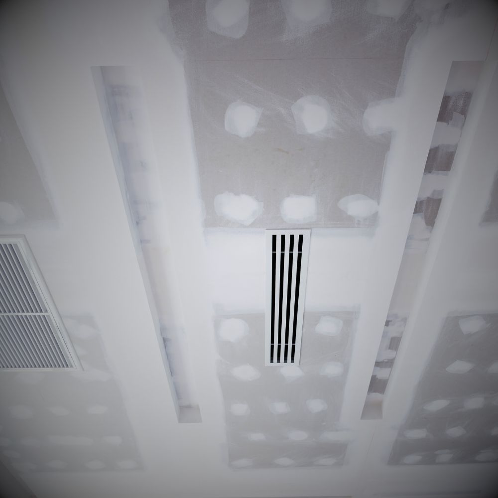 Hotel lobby with a grand plaster ceiling, complete with elegant moldings and chandelier lighting